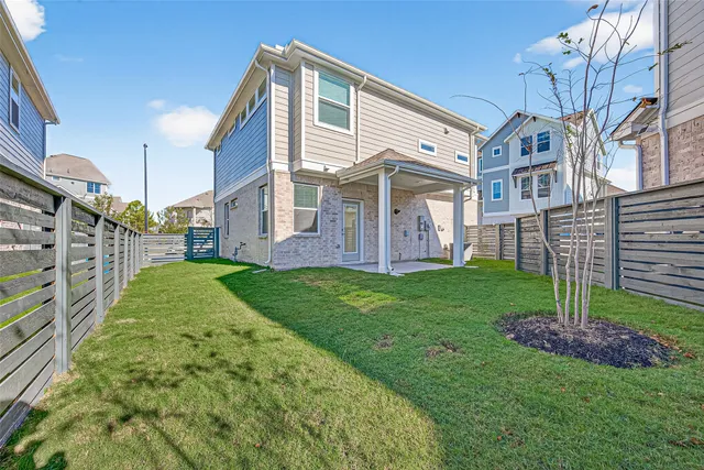 a view of a house with a yard and sitting area