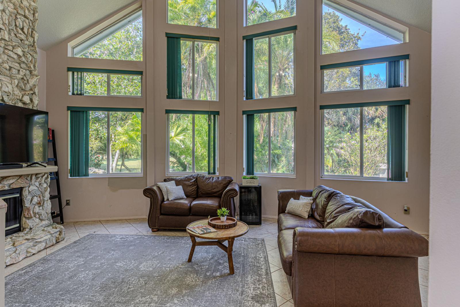 4852 Windmill Road Loxahatchee, FL 33470 - Photo 10 of 12 a living room with furniture tv and a window