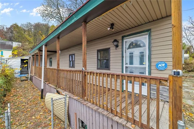 a view of a house with wooden fence