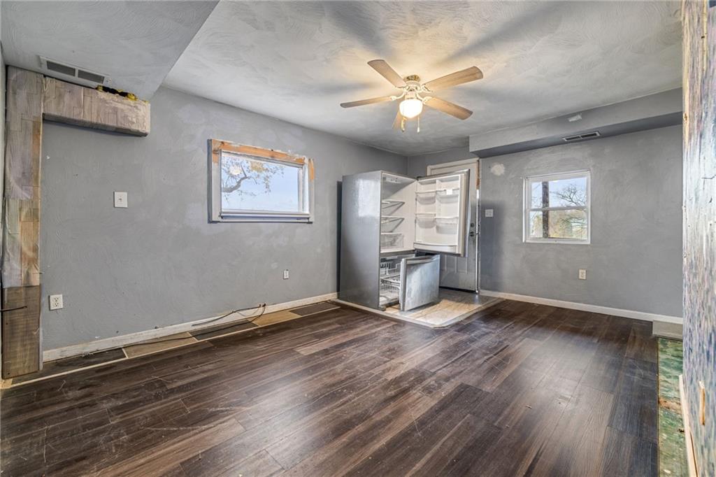 10 Welsh Way Pittsburgh, PA 15203 - Photo 12 of 46 an empty room with wooden floor chandelier fan and windows