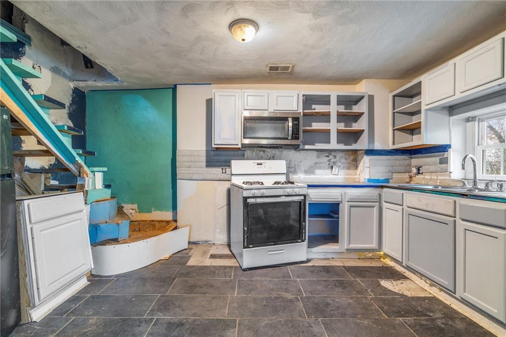 10 Welsh Way Pittsburgh, PA 15203 - Photo 13 of 46 a kitchen with stainless steel appliances granite countertop a stove a sink and a microwave