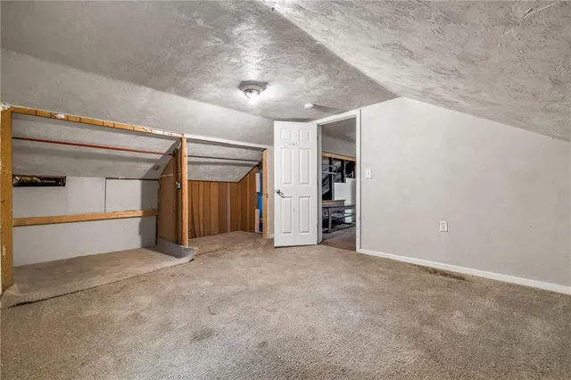 an empty room with furniture and a window