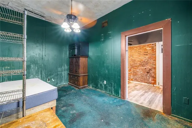 a bedroom with a bed and a chandelier