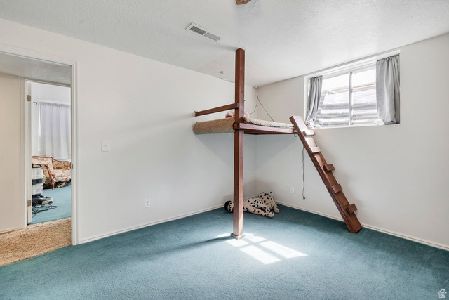 3334 Ute Road St. George, UT 84790 - Photo 32 of 40 Unfurnished bedroom with carpet floors and a textured ceiling