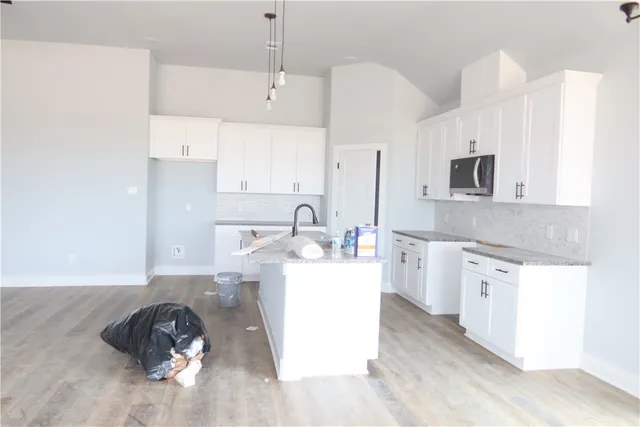 a kitchen with a sink dishwasher a stove and a refrigerator with wooden floor