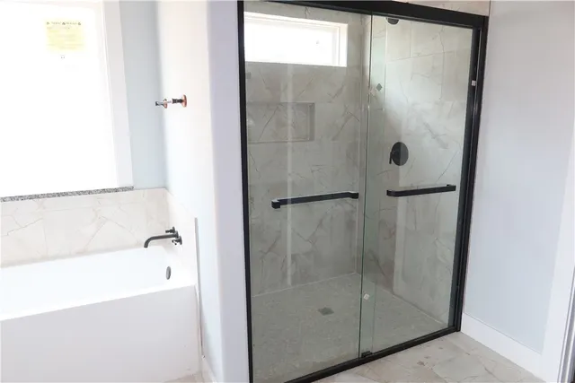 a bathroom with a glass shower door