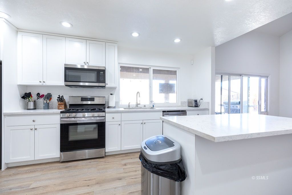 538 North Rio Bravo Street Ridgecrest, CA 93555 - Photo 12 of 45 a large kitchen with sink a stove and cabinets