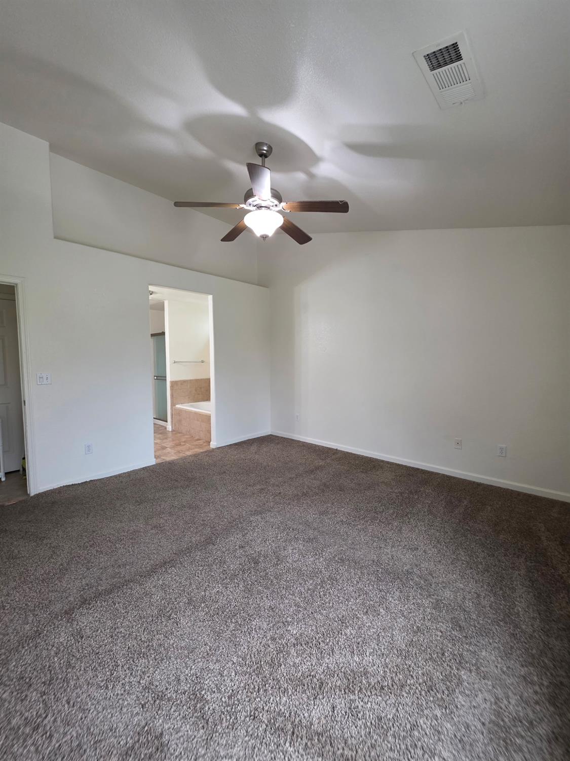 804 Morris Lane Madera, CA 93637 - Photo 10 of 17 a view of a room with a ceiling fan and a window