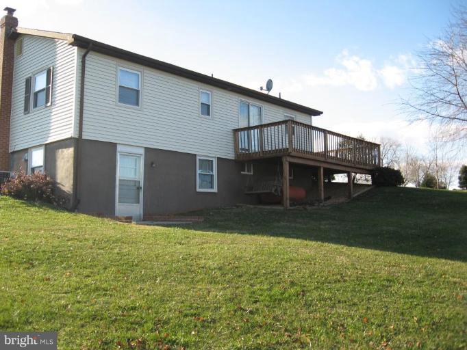9263 White Shop Road Culpeper, VA 22701 - Photo 4 of 8 Back yard showing deck and walk out basement