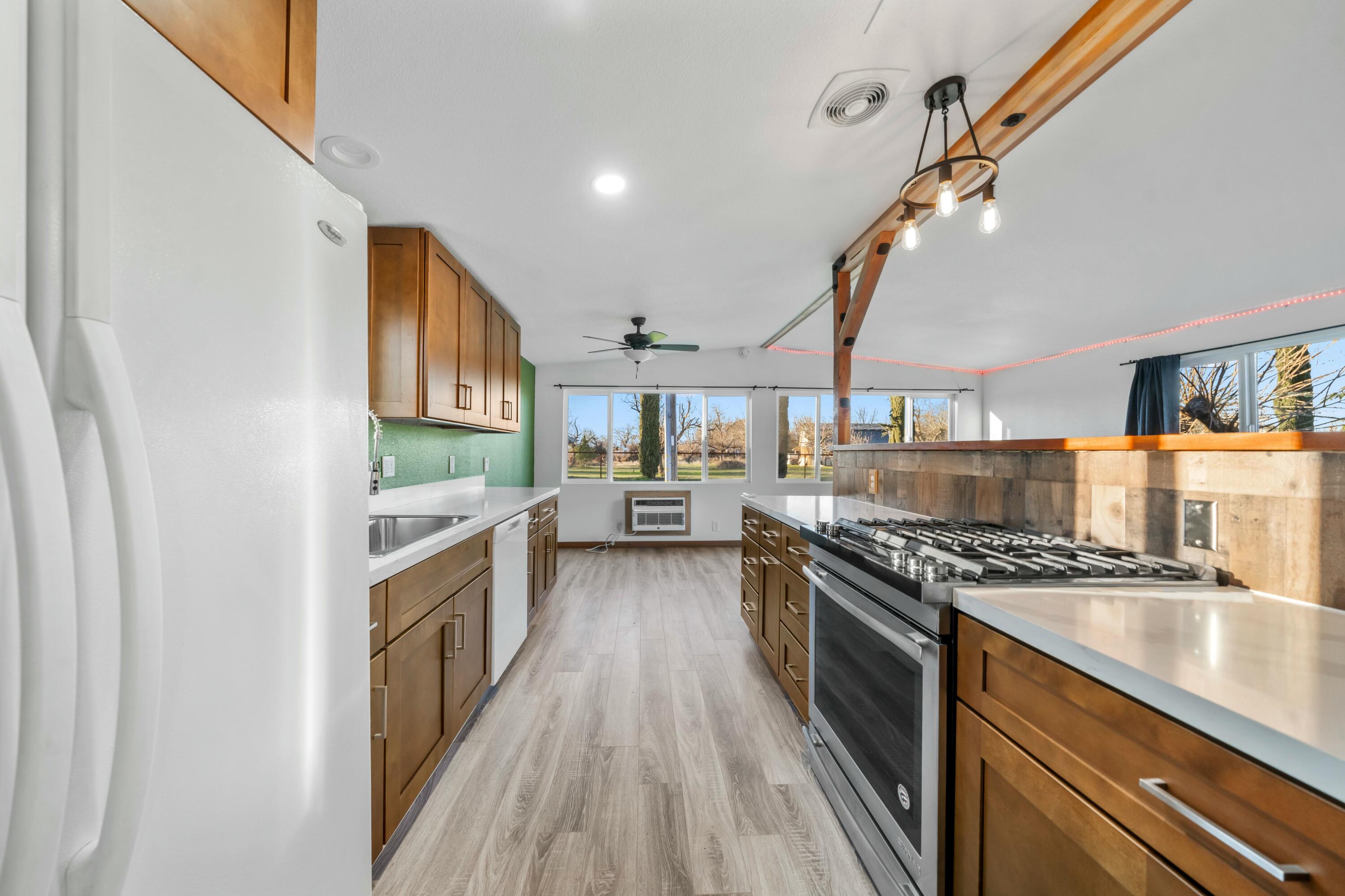 22235 Lone Tree Road, Unit 4 Anderson, CA 96007 - Photo 4 of 15 a kitchen with stainless steel appliances granite countertop a stove and a sink
