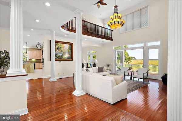 a living room with furniture a fireplace and a large window