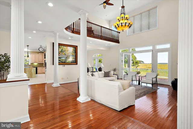 a living room with furniture a fireplace and a large window