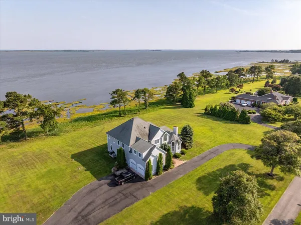 a view of a balcony with floor to ceiling windows and wooden fence