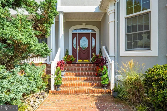 a living room with furniture and floor to ceiling windows
