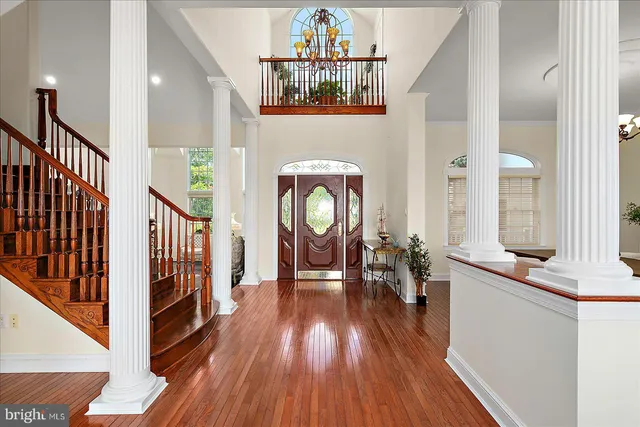 a view of a dining room with furniture a chandelier and a window