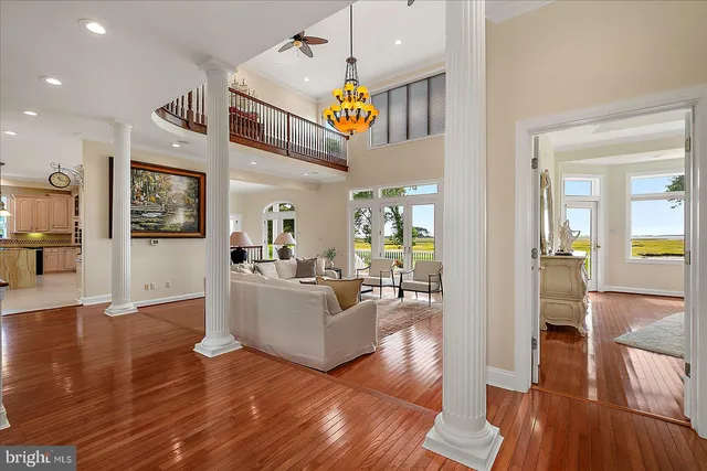 a dining room with furniture potted plants and wooden floor