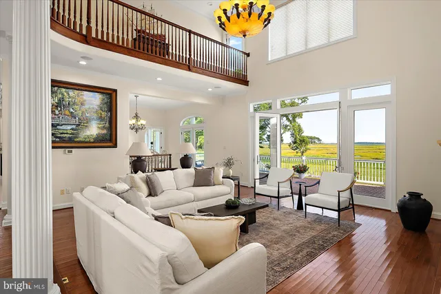 a view of a dining room with furniture wooden floor and chandelier