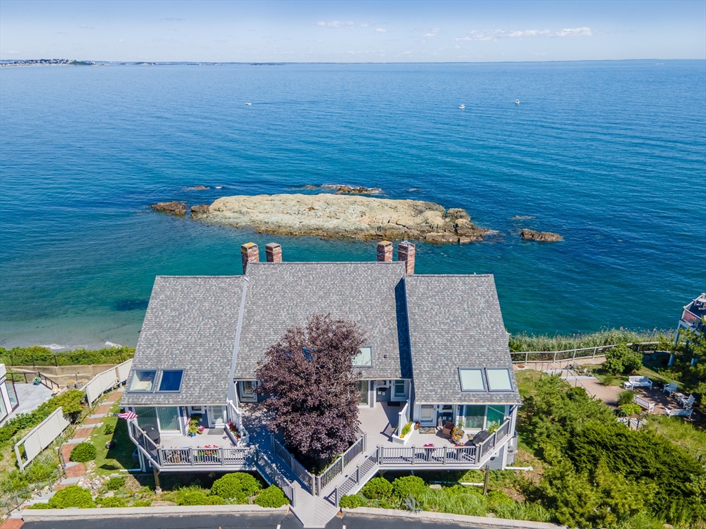 an aerial view of house with an ocean view
