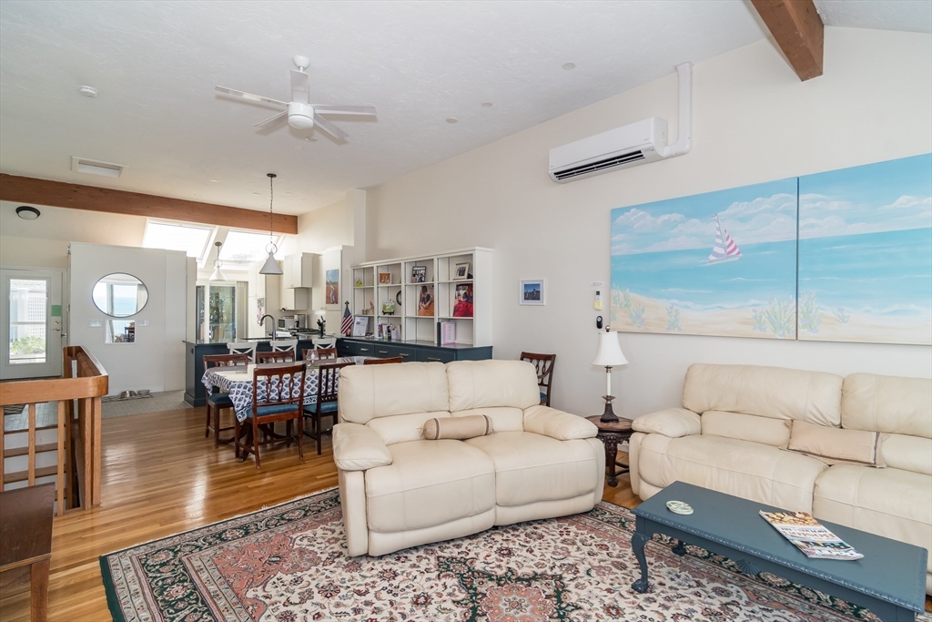 22 Oceanside Drive, Unit 22 Hull, MA 02045 - Photo 13 of 37 a living room with furniture and wooden floor