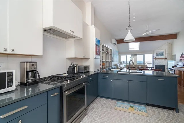 a kitchen with stainless steel appliances granite countertop a refrigerator and a stove