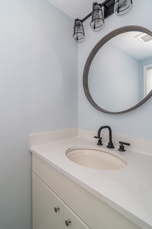 22 Oceanside Drive, Unit 22 Hull, MA 02045 - Photo 20 of 37 a bathroom with a sink and mirror