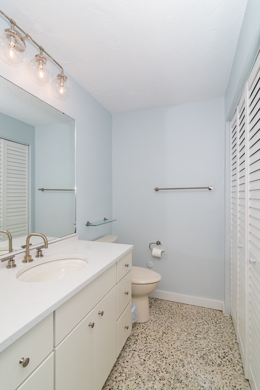 22 Oceanside Drive, Unit 22 Hull, MA 02045 - Photo 26 of 37 a bathroom with a sink a toilet and mirror