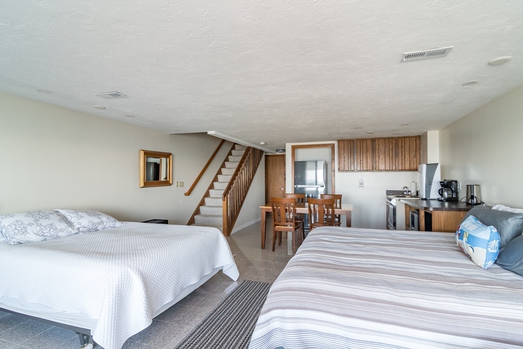22 Oceanside Drive, Unit 22 Hull, MA 02045 - Photo 29 of 37 a bedroom with double bed and a view of kitchen