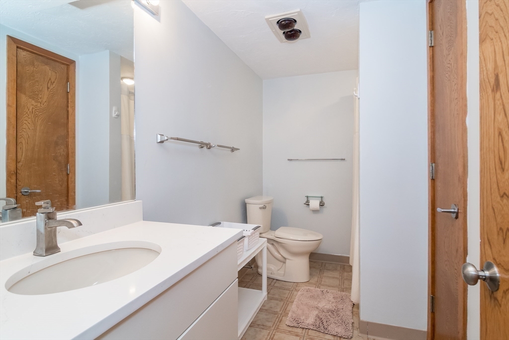 22 Oceanside Drive, Unit 22 Hull, MA 02045 - Photo 31 of 37 a bathroom with a sink and a mirror