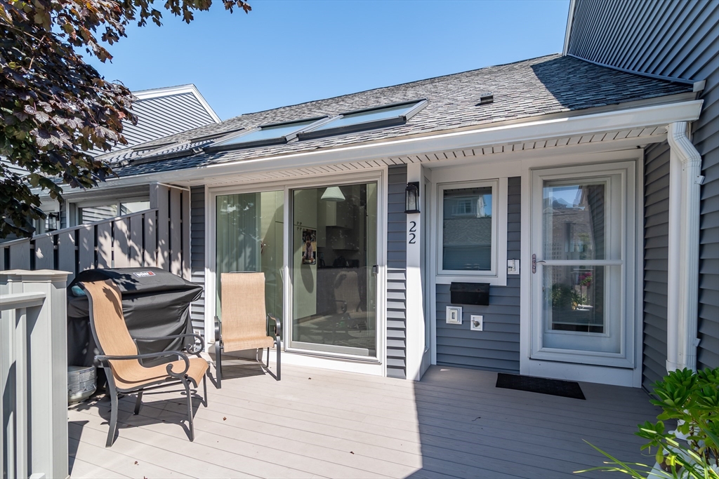 22 Oceanside Drive, Unit 22 Hull, MA 02045 - Photo 8 of 37 a view of a patio with table and chairs and potted plants