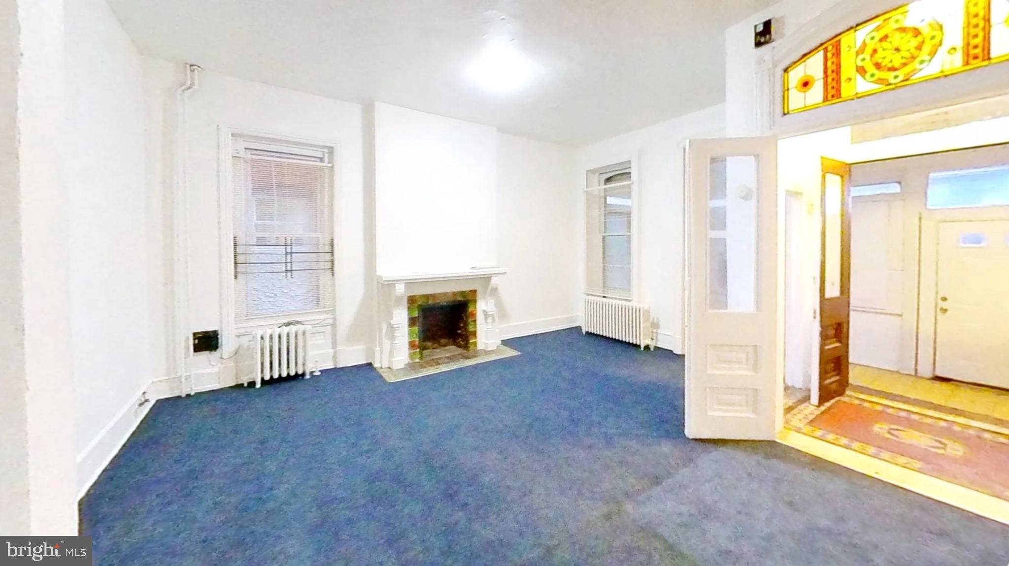 433 North 33rd Street Philadelphia, PA 19104 - Photo 5 of 27 an empty room with windows and fireplace