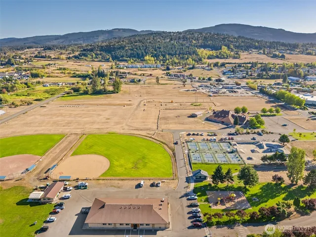 an aerial view of a swimming pool with a yard