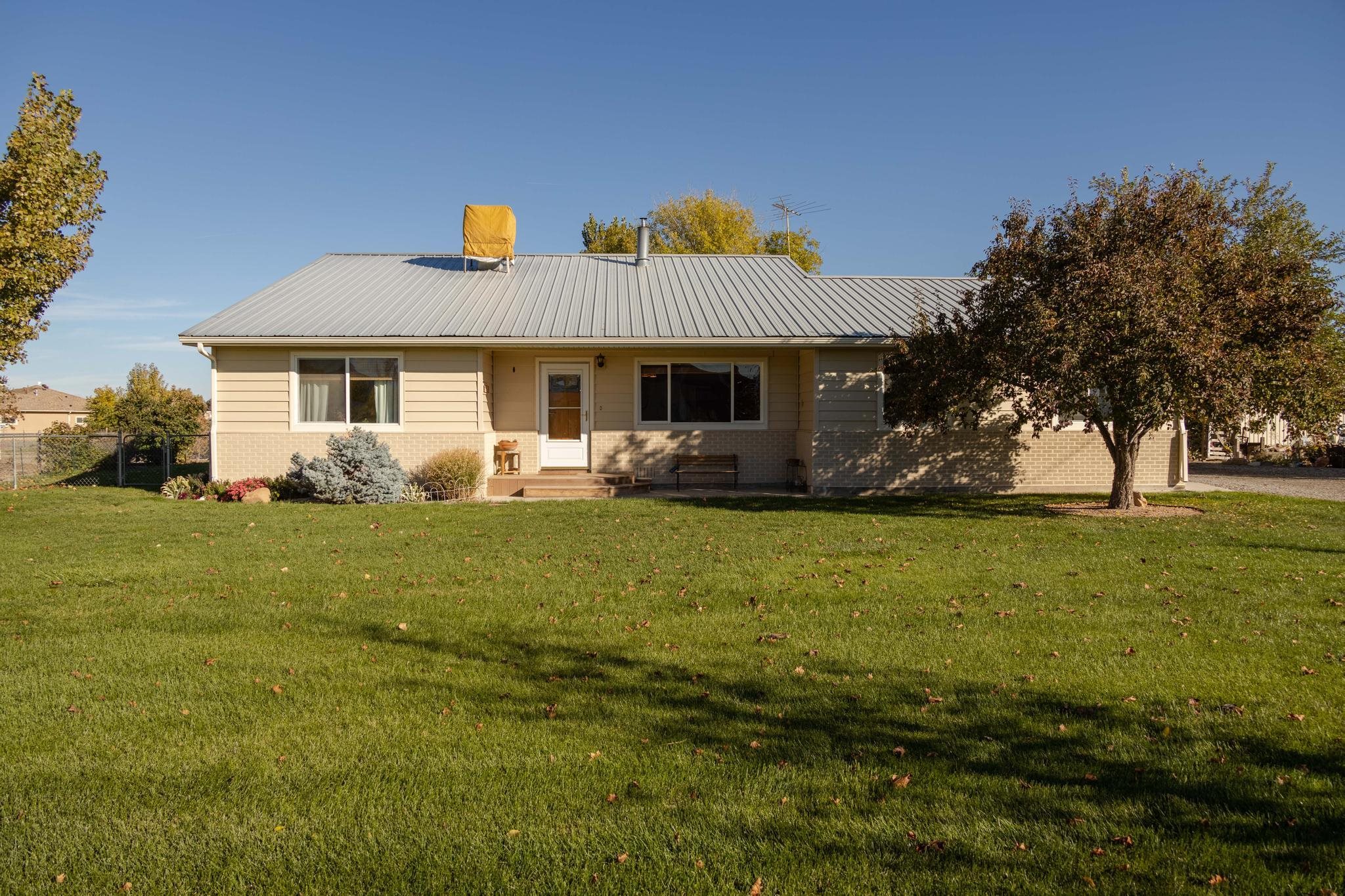 a front view of house with yard and green space