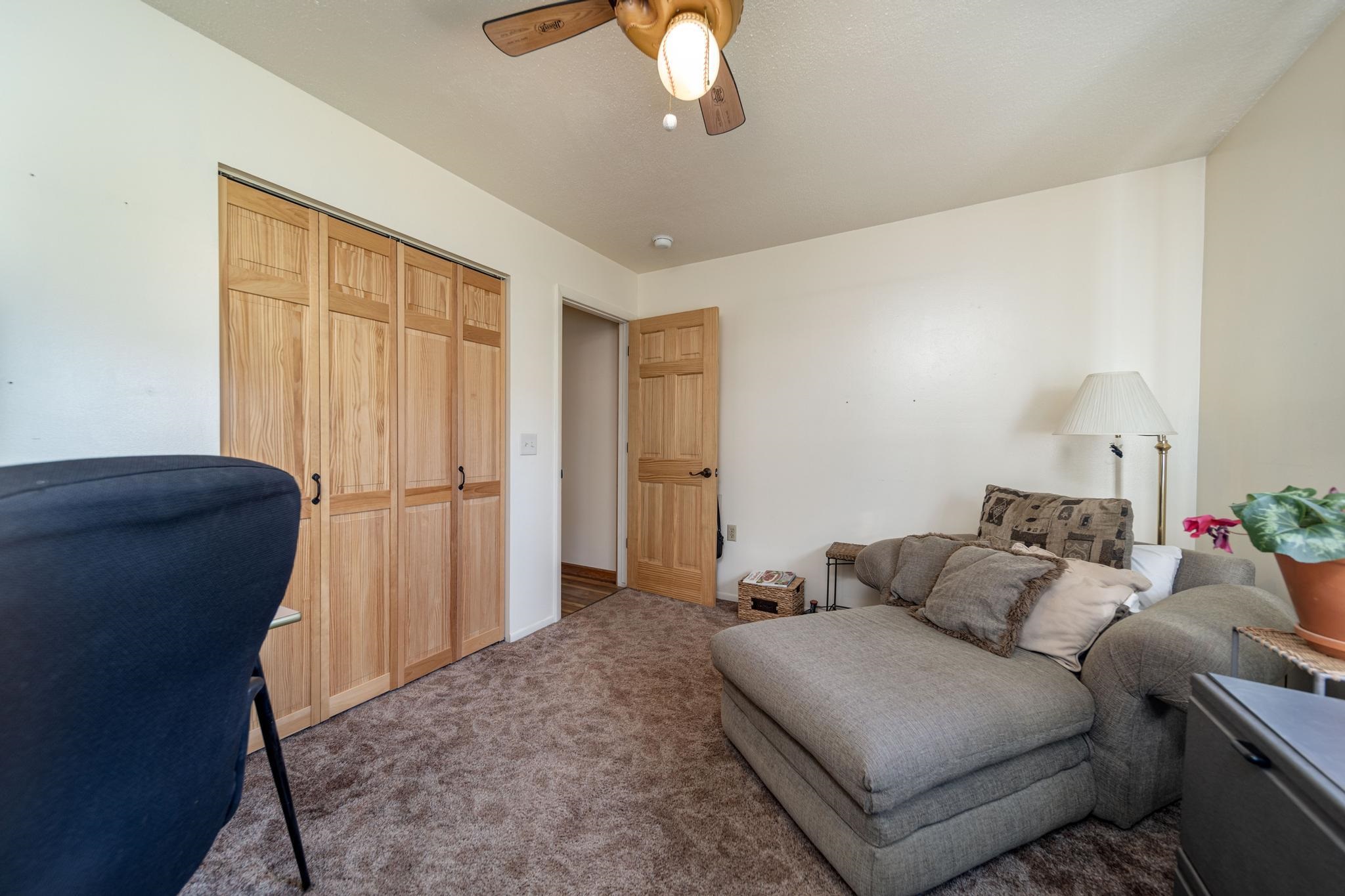 2034 J Road Fruita, CO 81521 - Photo 11 of 38 a living room with furniture and a chandelier