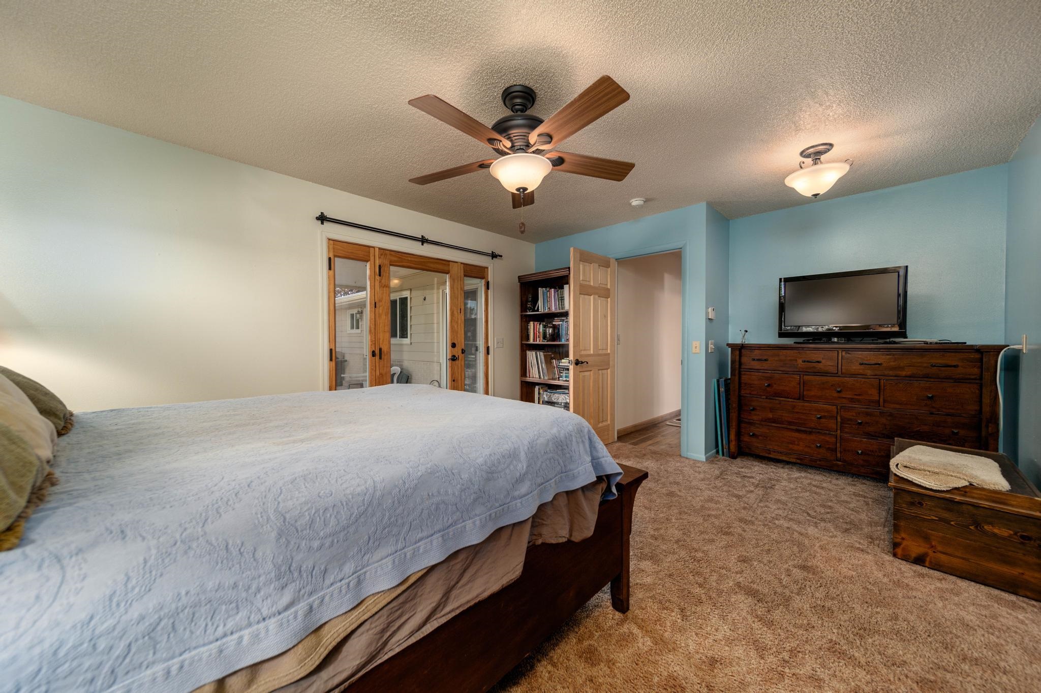 2034 J Road Fruita, CO 81521 - Photo 18 of 38 a bedroom with a bed and a flat screen tv