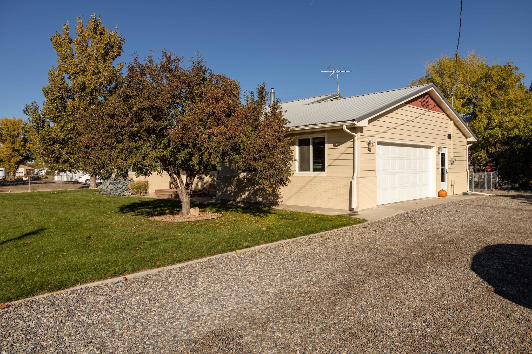 2034 J Road Fruita, CO 81521 - Photo 23 of 38 a view of a house with a yard