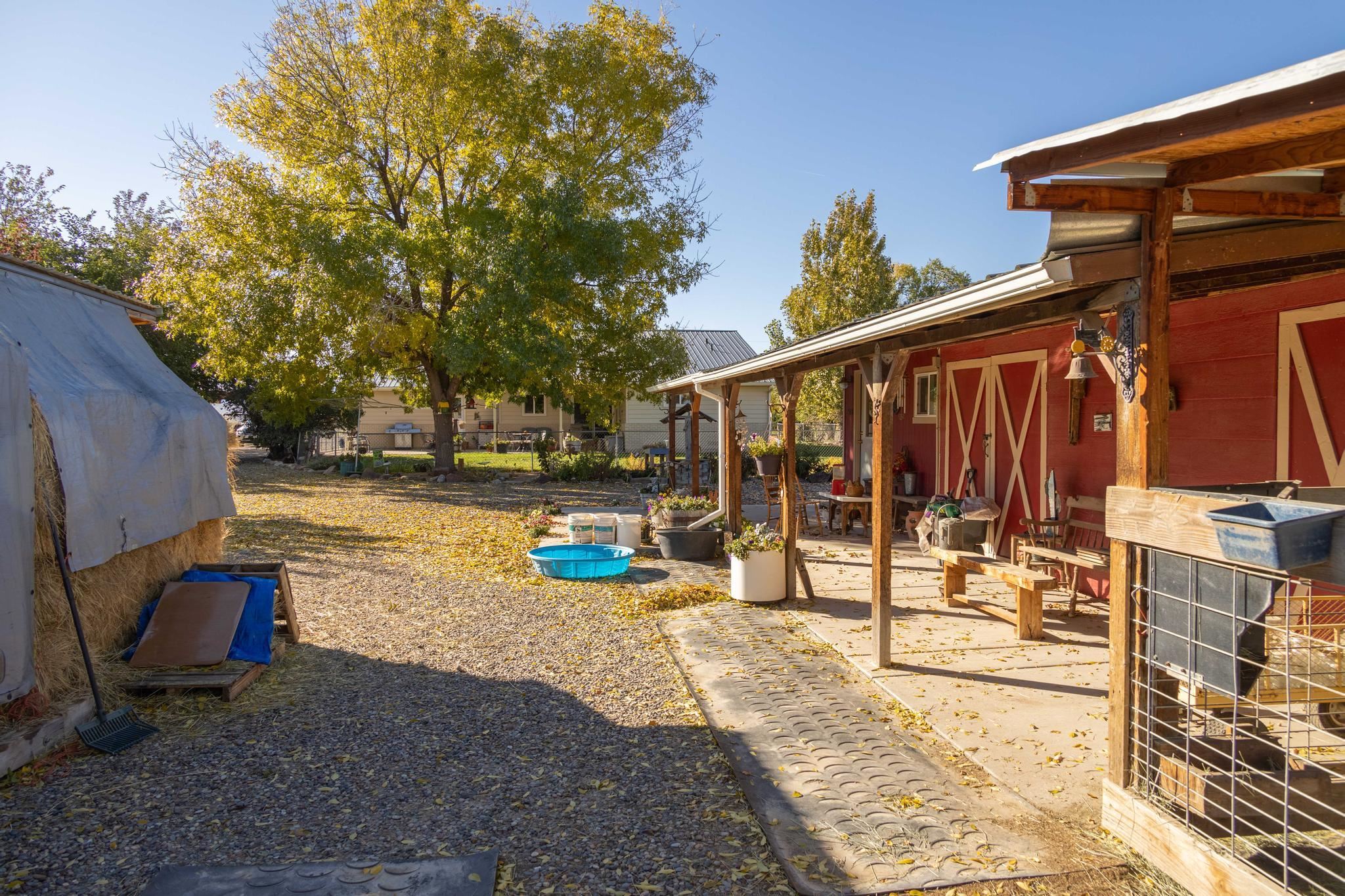 2034 J Road Fruita, CO 81521 - Photo 26 of 38 a view of a patio with a table and chairs and potted plants