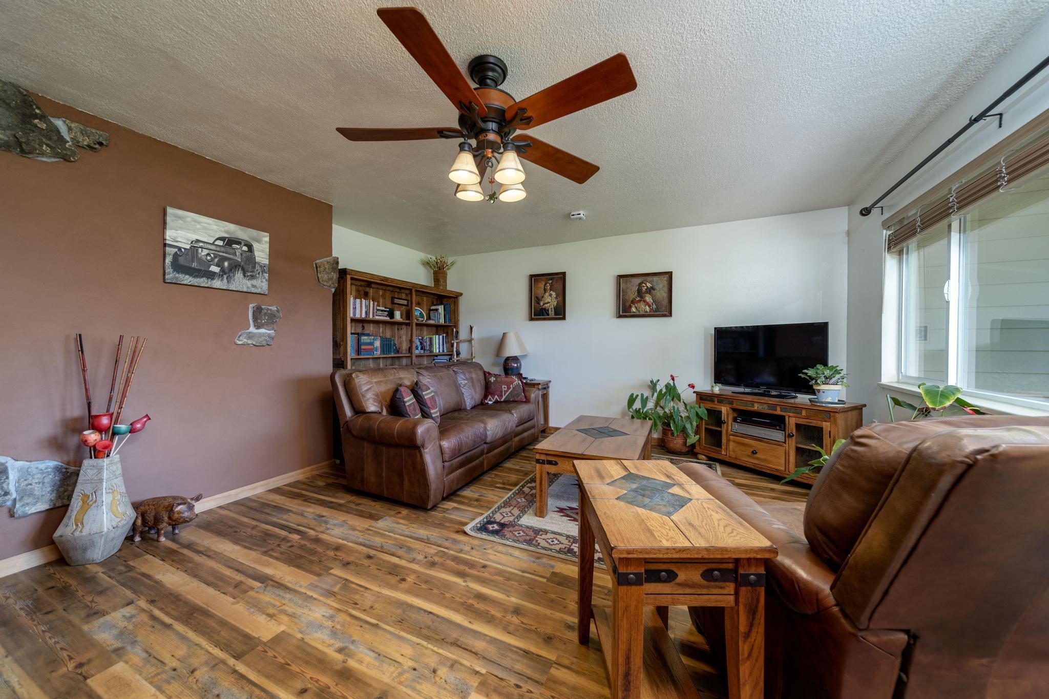 2034 J Road Fruita, CO 81521 - Photo 5 of 38 a living room with furniture a flat screen tv and a table