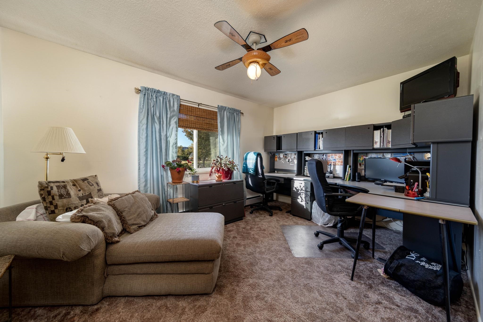 2034 J Road Fruita, CO 81521 - Photo 6 of 38 a living room with furniture ceiling fan and a window