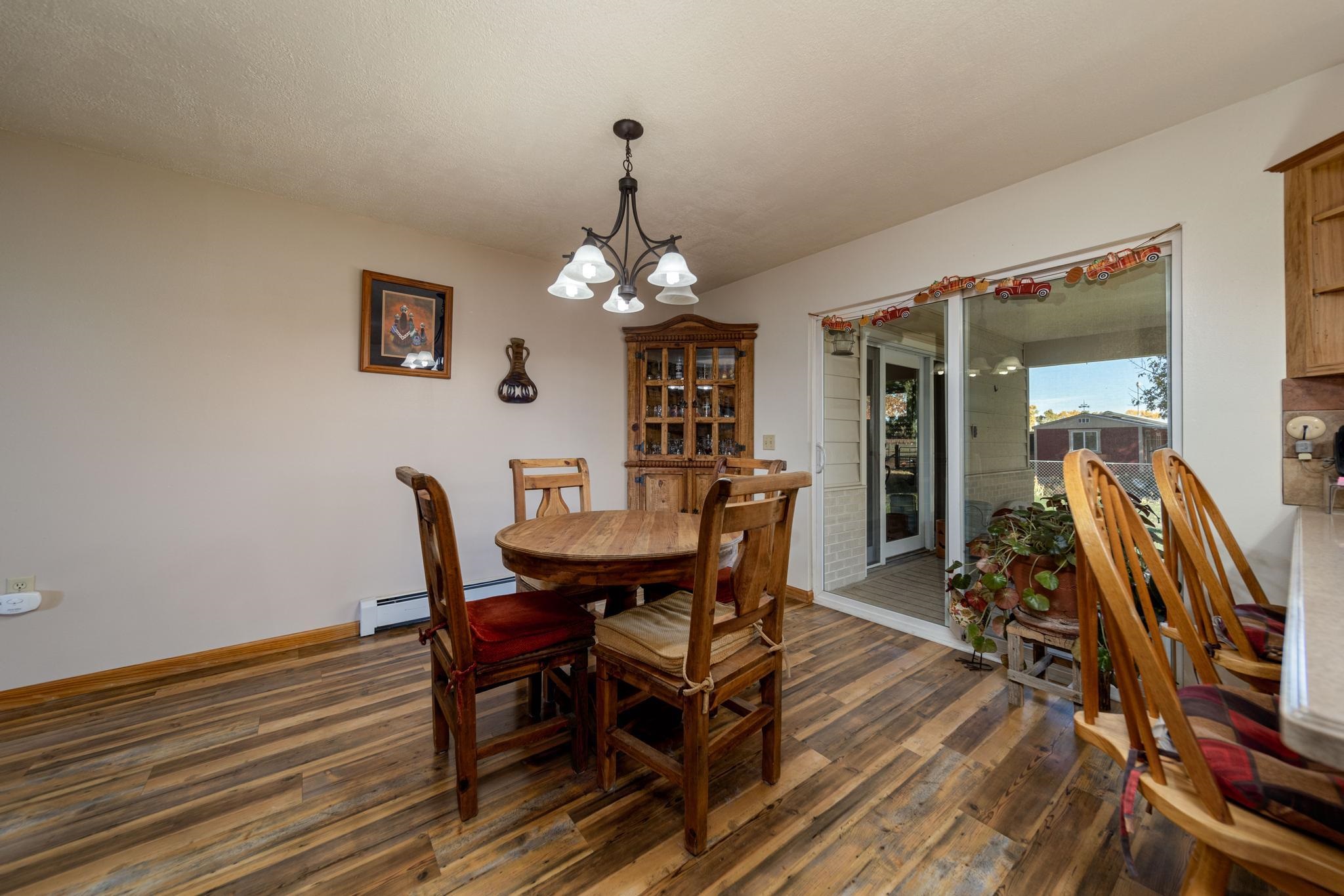 2034 J Road Fruita, CO 81521 - Photo 8 of 38 a view of a dining room with furniture and wooden floor