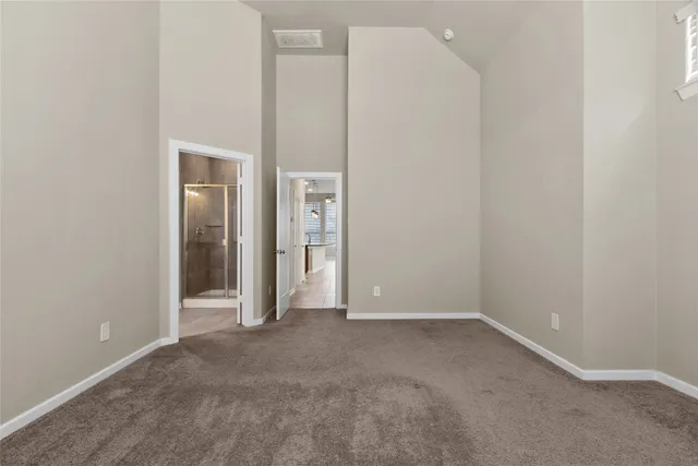 an empty room with closet and mirror