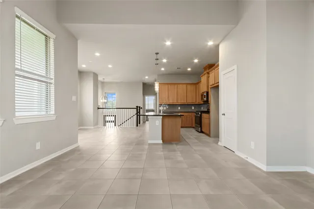 a view of kitchen with kitchen island sink and refrigerator