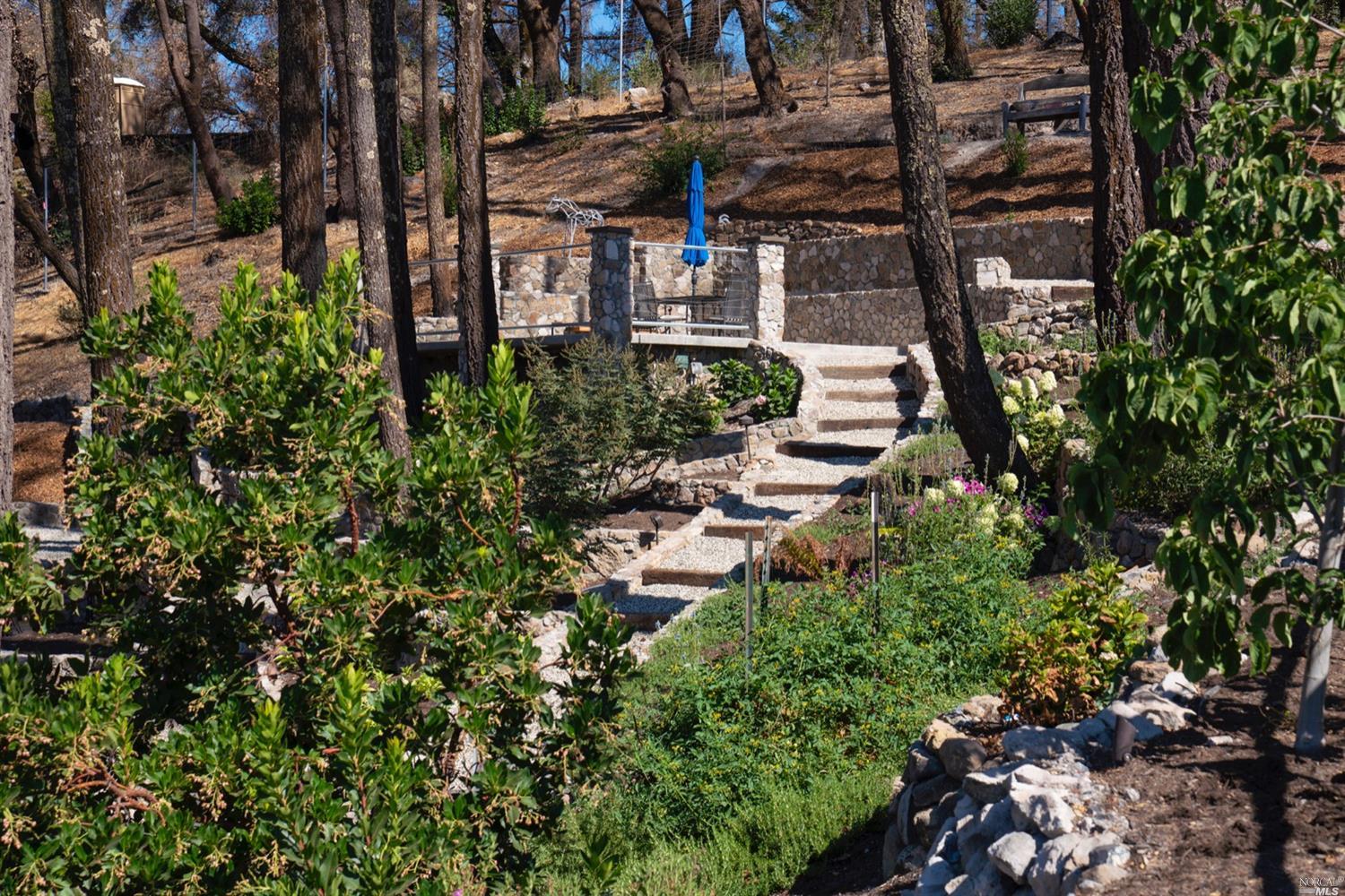 9 Bournemouth Road St. Helena, CA 94574 - Photo 32 of 40 a view of a building with a garden
