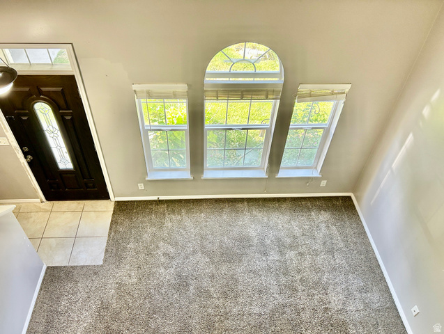 672 West 720 South Logan, UT 84321 - Photo 9 of 15 Vaulted ceiling room featuring three large windows, including an arched window