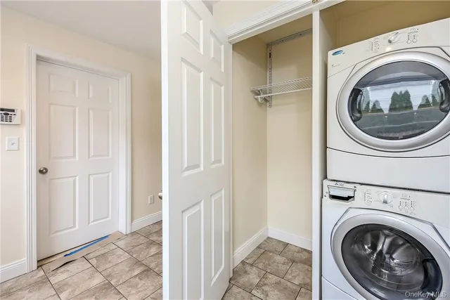 a view of a hallway with washer and dryer