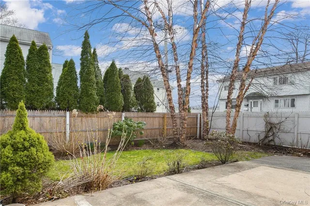 a view of a chair and table and wooden fence