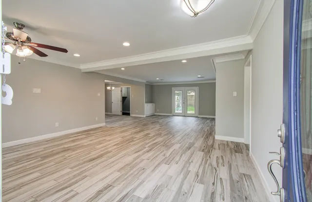 wooden floor in an empty room with a window