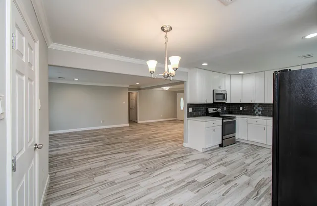 a view of kitchen with refrigerator and microwave