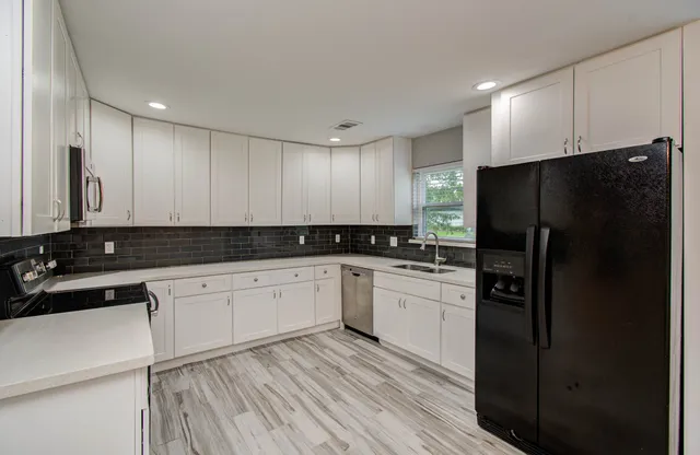 a kitchen with a refrigerator and a sink