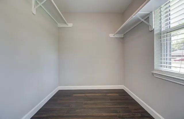 a view of a room with wooden floor and fan