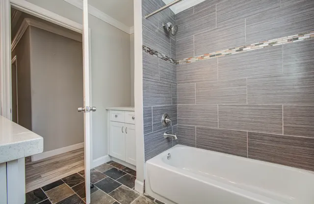 a bathroom with a bathtub and a shower